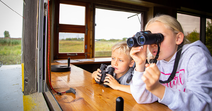 two children wildlife watching at RSPB Saltholme